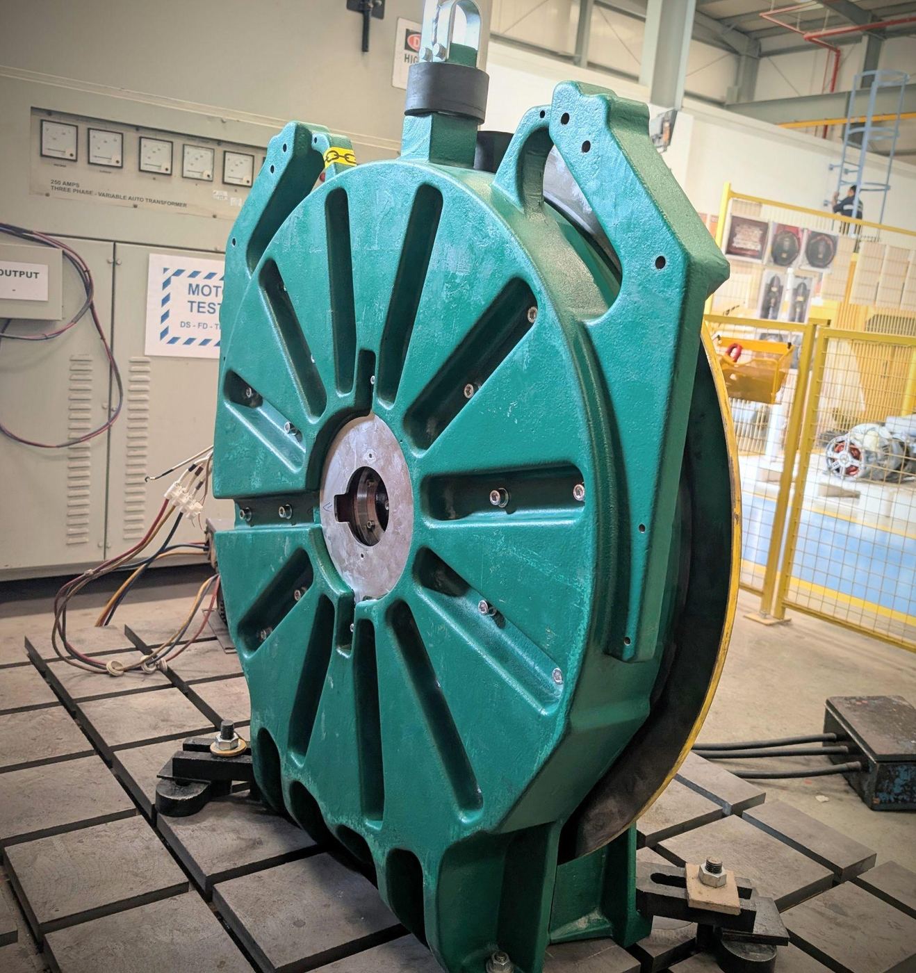 Gearless elevator traction machine with brake disc set up on the test bed after a PMSM overhaul