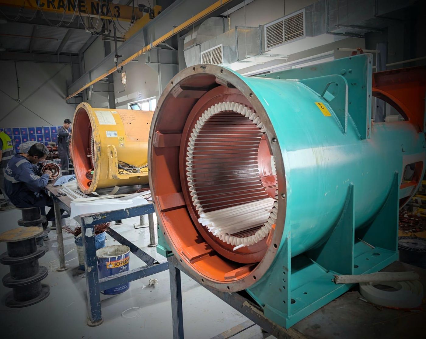 Repaired stator core mounted in an industrial electric motor housing before rewinding