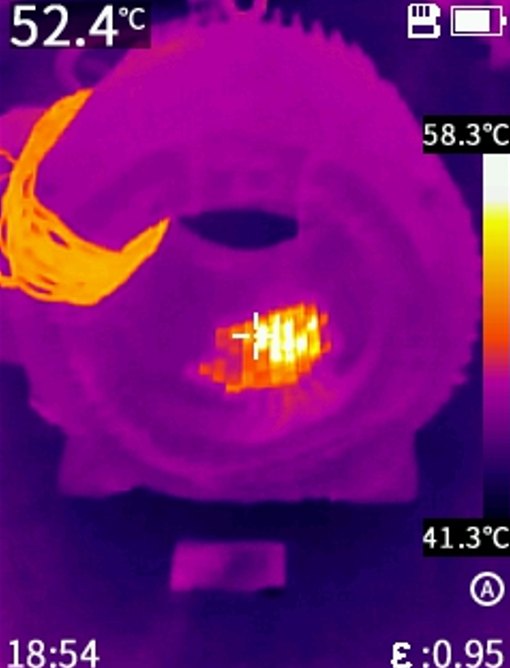 Thermal imaging scan of an electric motor stator core showing a localised hot spot at 52.4 degrees Celsius