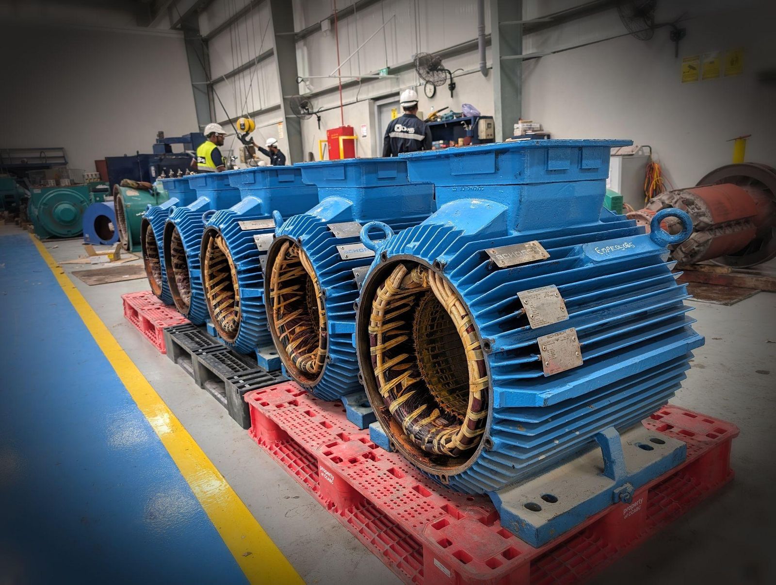 Chilled water pump motor stators lined up for rewinding and overhaul at the Daniel Group workshop