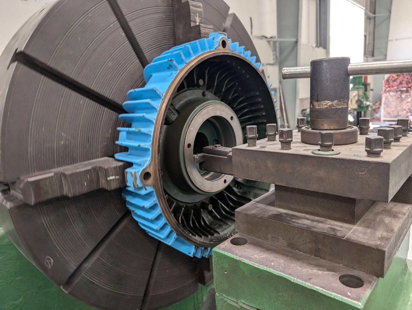 Industrial component clamped in a lathe chuck for precision machining and dimensional correction